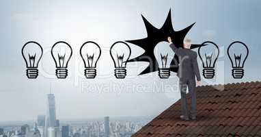 Businessman drawing light bulbs while standing on roof