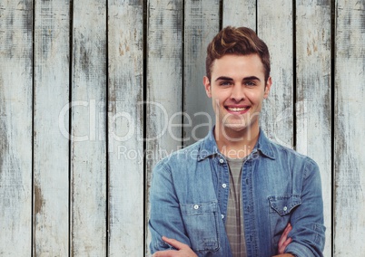 Portrait of happy businessman against wooden wall