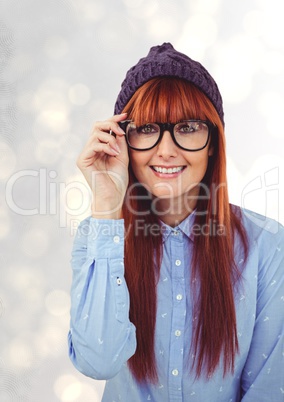 Portrait of happy redheaded female hipster wearing eyeglasses and knit hat