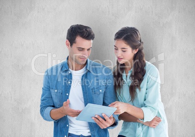 Business people using digital tablet against gray background