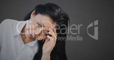 Woman head in hand against grey background