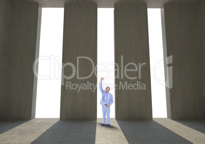 Successful businessman standing against columns