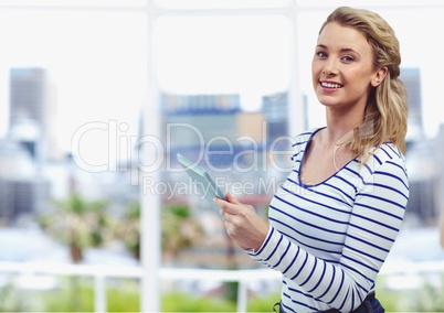 Smiling young woman holding digital tablet outdoors