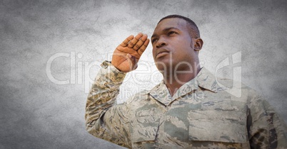 Soldier saluting against white wall with grunge overlay