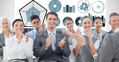 Business people applauding with graphs in background