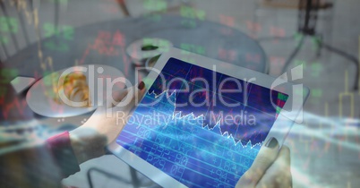 Digital composite image of businesswoman's hands holding tablet PC with graph on screen