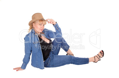 Blond woman sitting on floor.