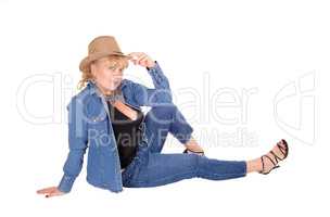 Blond woman sitting on floor.