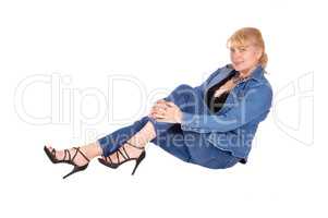 Woman in jeans sitting on floor.