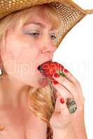 Closeup of woman eating strawberry.