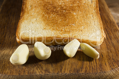 Fried bread and cloves of fresh garlic