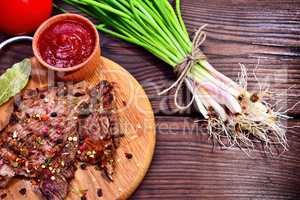 Fried veal in spices and with tomato sauce