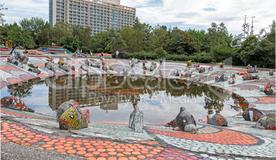 A small pond , whose banks are decorated with sculptural images