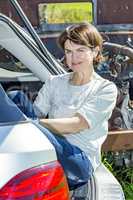 Woman sitting in trunk of car