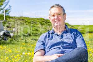 Man enjoys the leisure time in a flower meadow