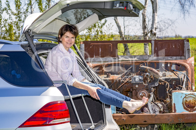 Woman sitting in trunk of car