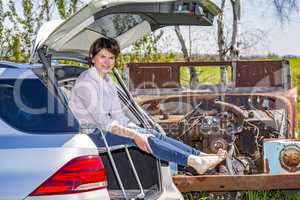 Woman sitting in trunk of car