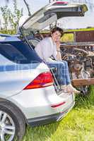 Woman sitting in trunk of car