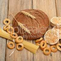 bread, pasta and pastries on wooden surface