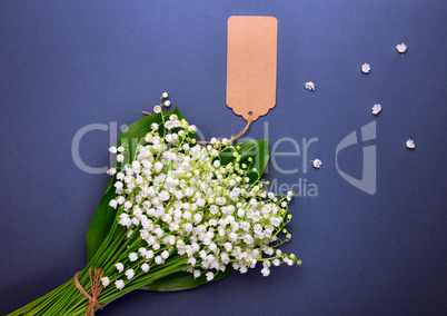Bouquet of white lily-of-the-valley with an empty paper tag