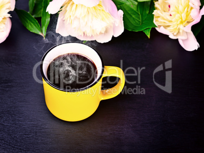 Coffee in a yellow mug on a black surface