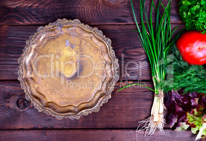 Empty copper dish on a brown background