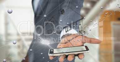 Midsection of business person with house over smart phone