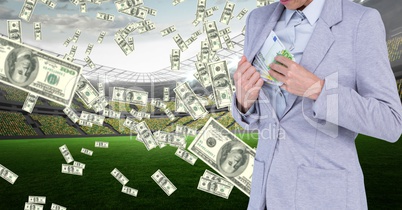Businesswoman hiding money in jacket at football stadium representing corruption