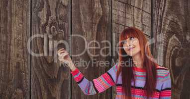Redhead woman against wooden wall