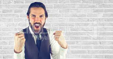 Hipster screaming against wall
