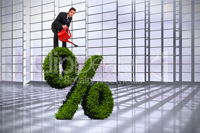 Composite image of businessman watering with red can