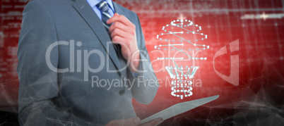 Composite image of businessman holding digital tablet