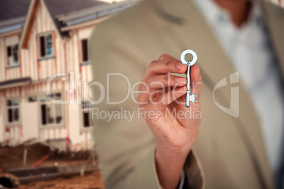 Composite image of mid section of business executive showing house key