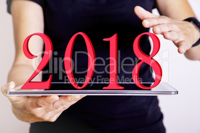 Person with tablet PC and year 2018