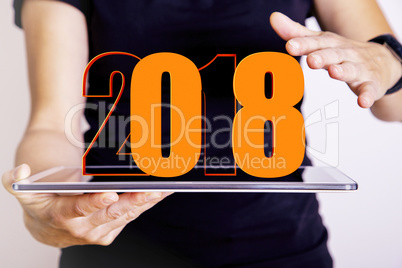 Person with tablet PC and year 2018