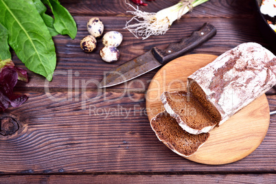 Rye bread sliced on a wooden kitchen board
