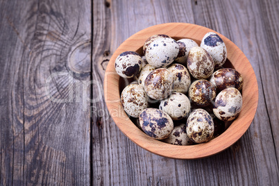 Quail eggs in a wooden plate