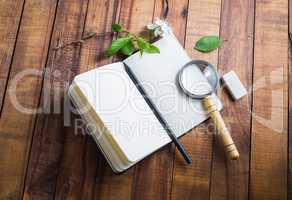 Notebook, magnifier, pencil