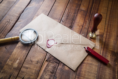 Envelope, magnifier and seal