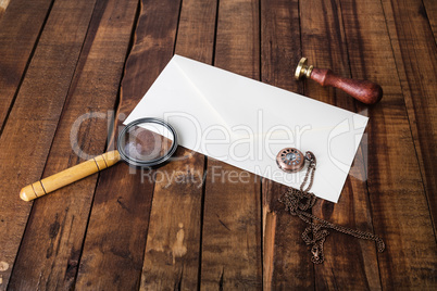 Envelope, magnifier, stamp and clock
