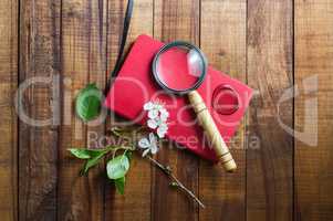 Red notebook and magnifier