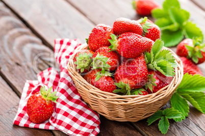 Fresh strawberry in basket on wooden rustic table, closeup. Delicious, juicy, red  berries. Healthy eating.