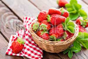 Fresh strawberry in basket on wooden rustic table, closeup. Delicious, juicy, red  berries. Healthy eating.