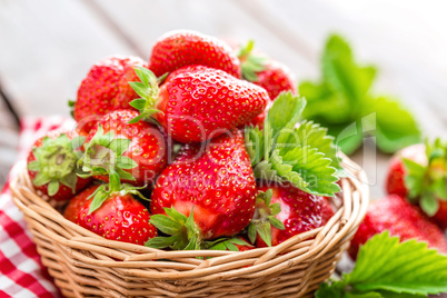 Fresh strawberry in basket on wooden rustic table, closeup. Delicious, juicy, red  berries. Healthy eating.