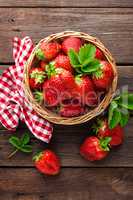 Fresh strawberry in basket on wooden rustic table, closeup. Delicious, juicy, red  berries. Healthy eating.