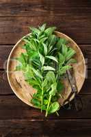 Fresh mint leaves on wooden rustic table, top view