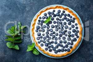 Delicious dessert blueberry tart with fresh berries and whipped cream, sweet tasty cheesecake, berry pie. French cuisine