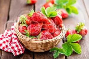 Fresh strawberry in basket on wooden rustic table, closeup. Delicious, juicy, red  berries. Healthy eating.