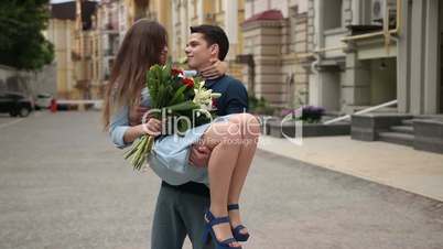 Loving man carrying his beloved girl in his arms