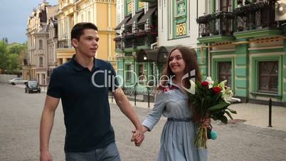 Romantic couple in love strolling down city street